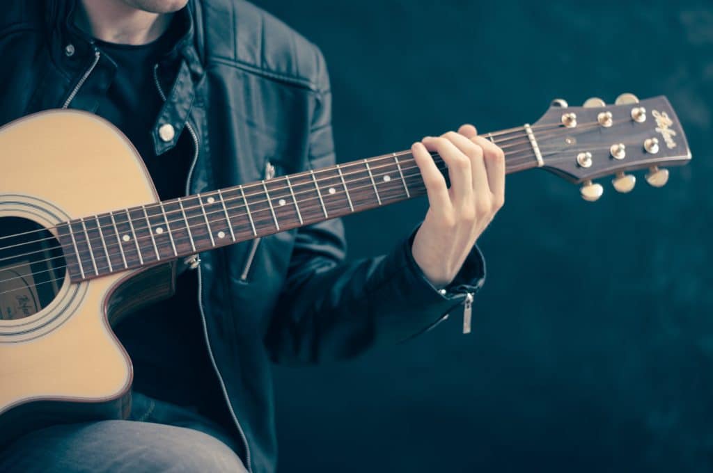 Using two microphones on an acoustic guitar will introduce phase cancellation.