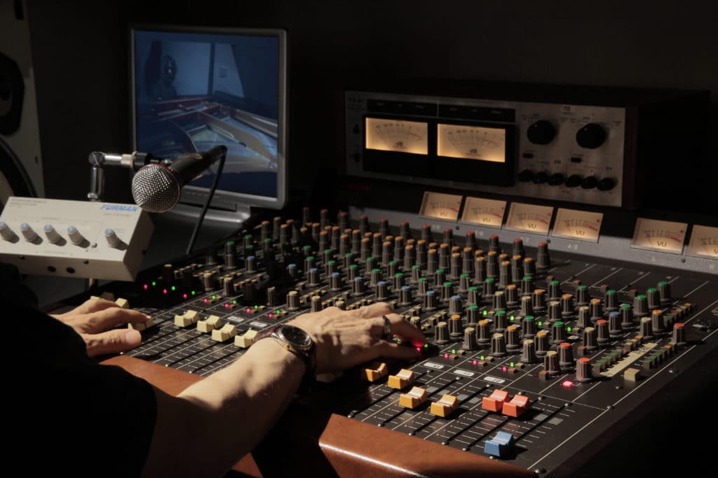 A music producer would find the recording, mixing and sometimes the mastering engineers for a record.
